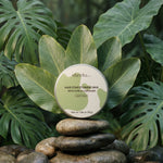 shveta labs hair conditioning wax on stones with green leaves in the background